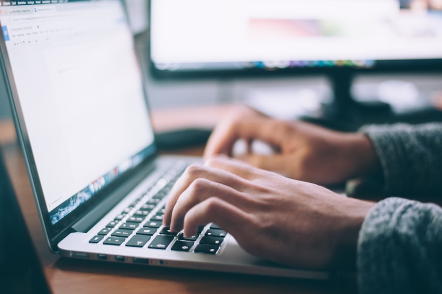 Researcher working at a desk with notes and a laptop